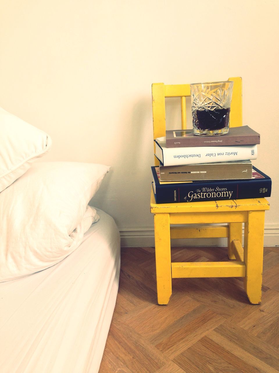 indoors, table, still life, book, high angle view, education, absence, wood - material, empty, yellow, pen, close-up, copy space, home interior, no people, desk, pencil, musical instrument, hardwood floor, studio shot