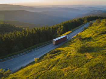 High angle view of road amidst trees and mountains