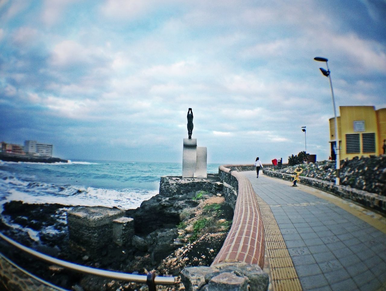 sea, sky, horizon over water, cloud - sky, water, built structure, architecture, building exterior, the way forward, beach, cloudy, incidental people, cloud, lighthouse, shore, nature, guidance, street light, railing, day