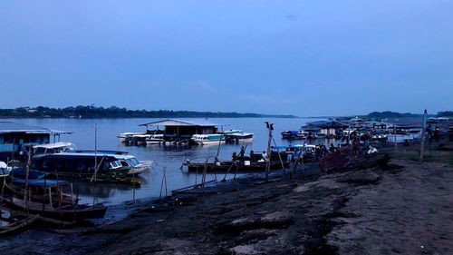 Boats moored in sea against sky