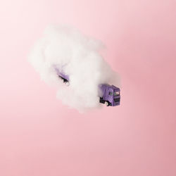 Purple truck in cloud on pink background. growth, future, development concept. minimal compostition.