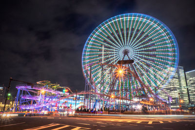 Illuminated ferris wheel at night