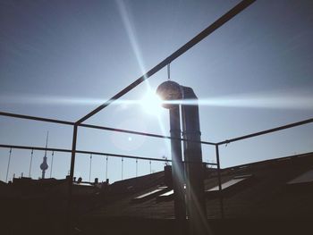 Low angle view of sun shining through clouds