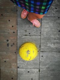 Low section of woman standing on footpath