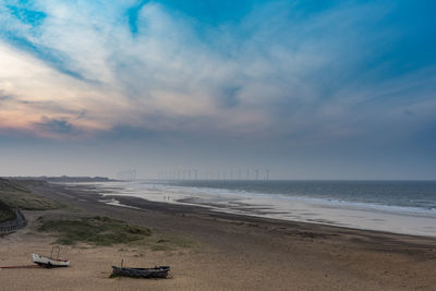 Scenic view of beach against sky during sunset