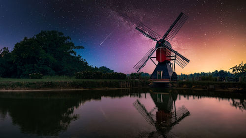 Scenic view of lake against sky at night