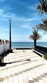 View of swimming pool by sea against sky