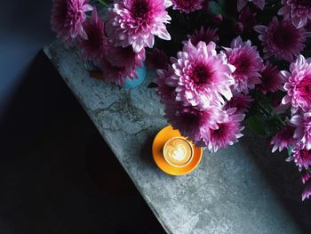 Flower vase with coffee on table at home
