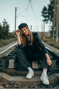 Portrait of young woman sitting outdoors