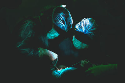 Close-up of people against black background