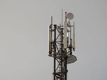 Low angle view of communications tower against clear sky