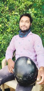 Portrait of young man holding purple outdoors