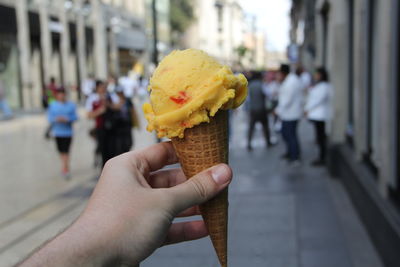 Hand holding ice cream cone