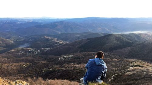 Rear view of man walking on mountain