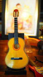 Close-up of guitar on table at home