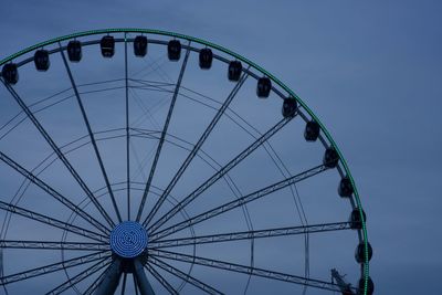 Low angle view of ferris wheel against blue sky