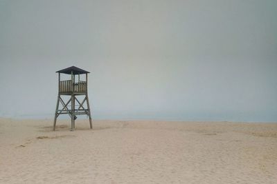 Lifeguard hut on beach against clear sky