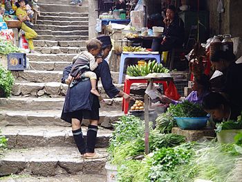 Rear view of woman standing against built structure