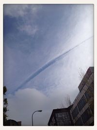 Low angle view of building against cloudy sky