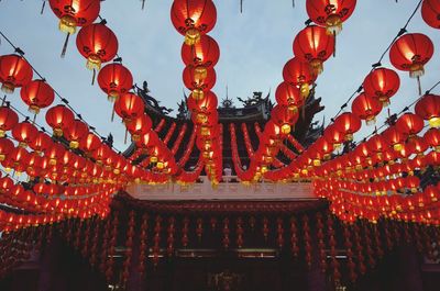 Illuminated lanterns hanging outside temple