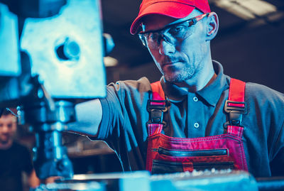 Portrait of young man working in factory