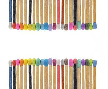 High angle view of multi colored pens on white background