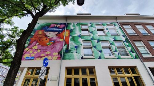 Low angle view of multi colored building against trees