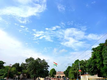 Low angle view of flag against blue sky