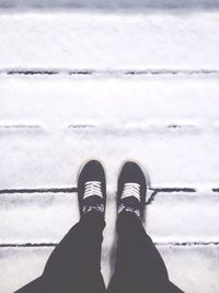 View of human feet on tiled floor