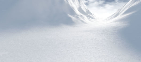 Snow covered land against sky