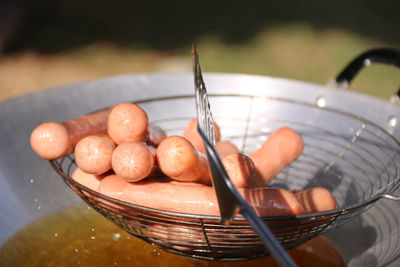 Close-up of sausages frying in wok