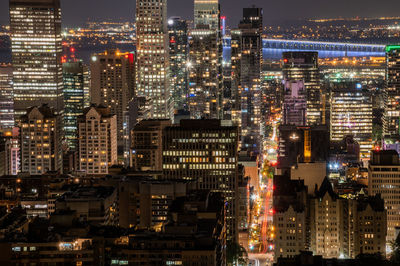 High angle view of city lit up at night