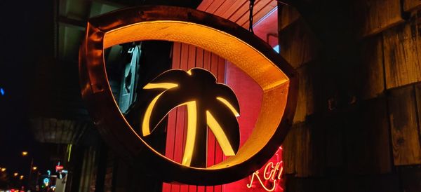 Low angle view of illuminated lights in city at night