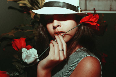 Close-up portrait of teenage girl holding artificial flower