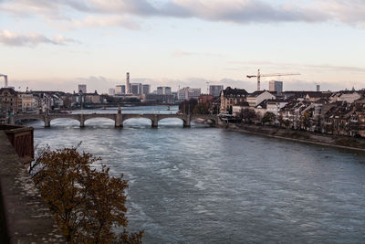 Bridge over river against cloudy sky