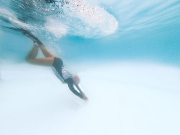 Woman swimming in sea during winter