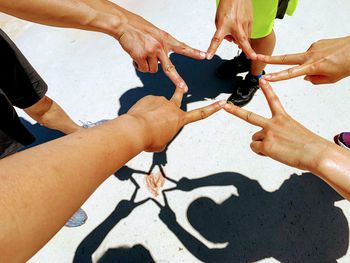 Friends making sign with hands