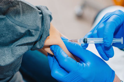 Close-up of doctor giving injection to patient