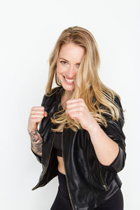 Portrait of smiling young woman against white background