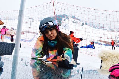 Portrait of woman waiting at ski field