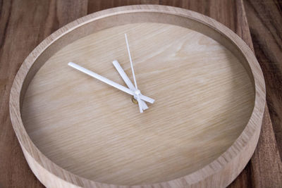 Low angle view of wooden clock on wall