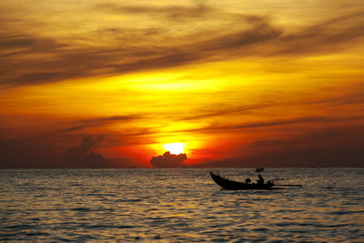 Silhouette boat in sea against sky during sunset