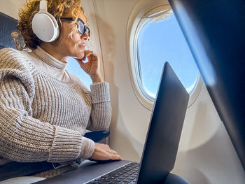 Young woman using laptop while sitting at home