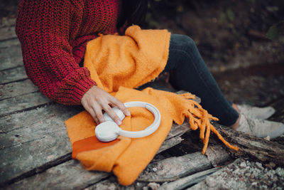High angle view of hand holding orange outdoors