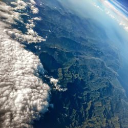 High angle view of sea and mountains against sky