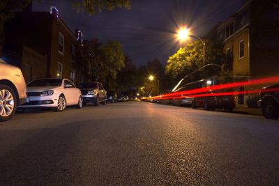 Road passing through city street at night