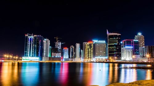 Illuminated city at waterfront