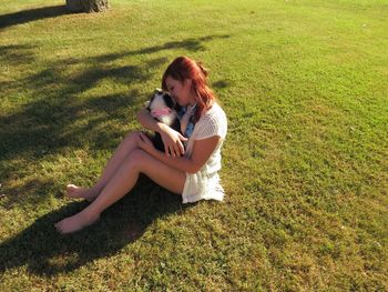 Woman sitting on grassy field