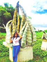 Portrait of smiling young woman standing on field
