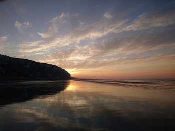 Scenic view of beach against sky during sunset